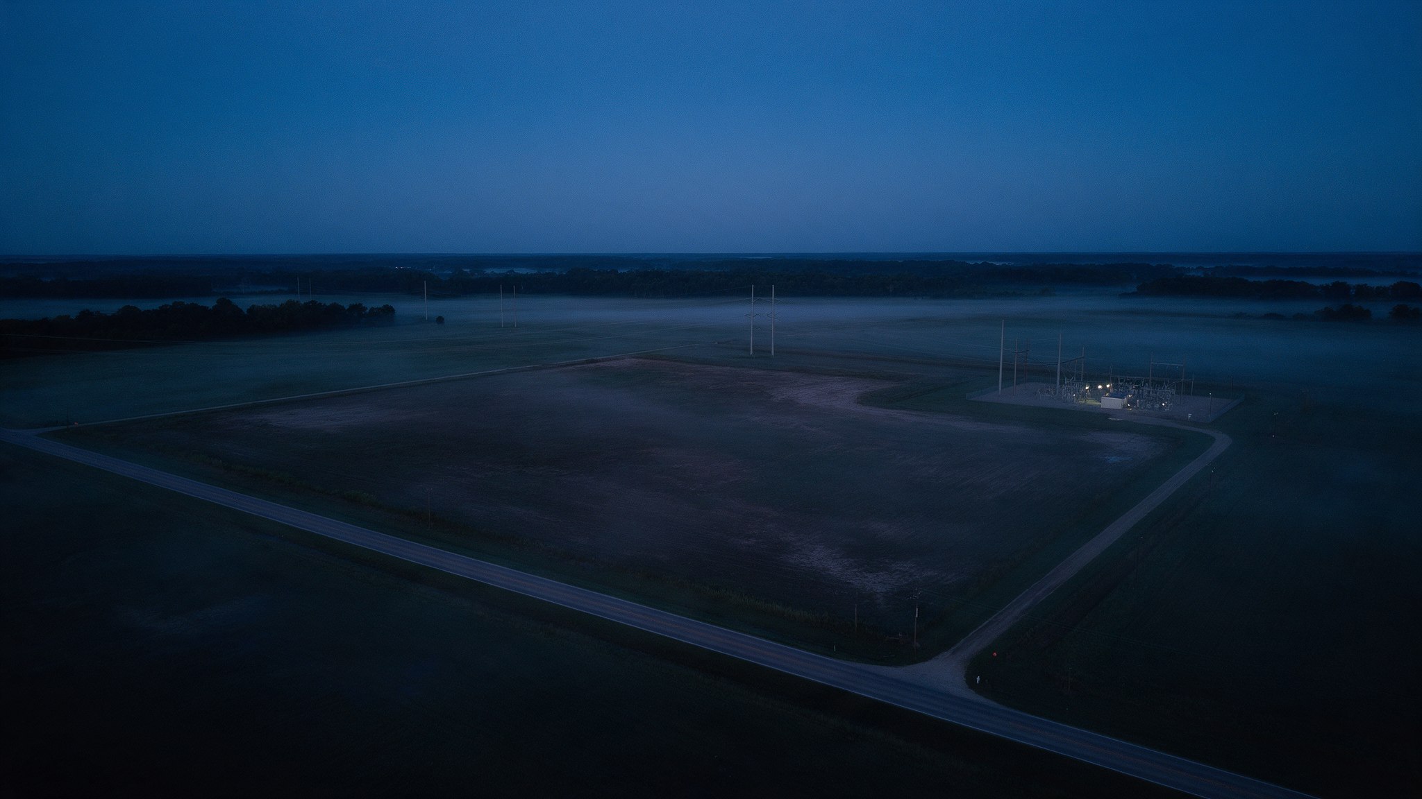 Aerial view of a cleared greenfield site at dusk