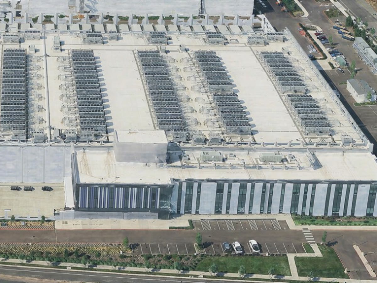 Aerial view of a 70 MW design-build data center with rooftop cooling and a glass-fronted office wing